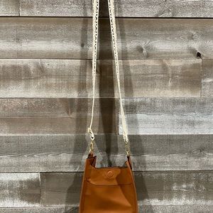 Small cross body bag with super cute guitar strap!